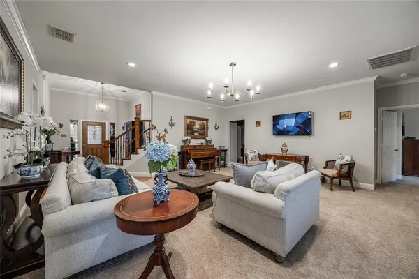 a living room with furniture and a chandelier