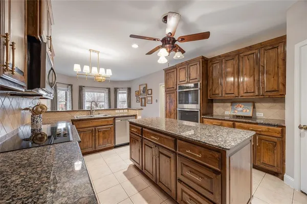 a kitchen with stainless steel appliances granite countertop a sink and stove