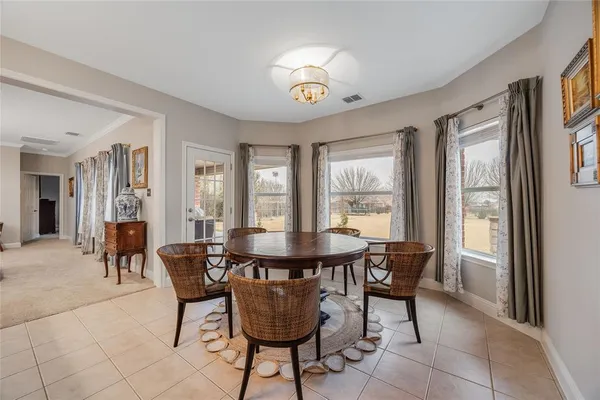a view of a dining room with furniture and a chandelier