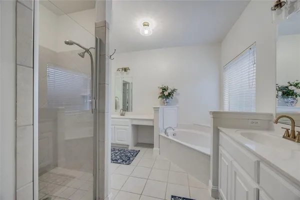 a bathroom with a bathtub shower sink and toilet