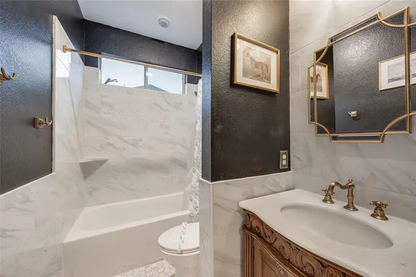a bathroom with a sink toilet and shower