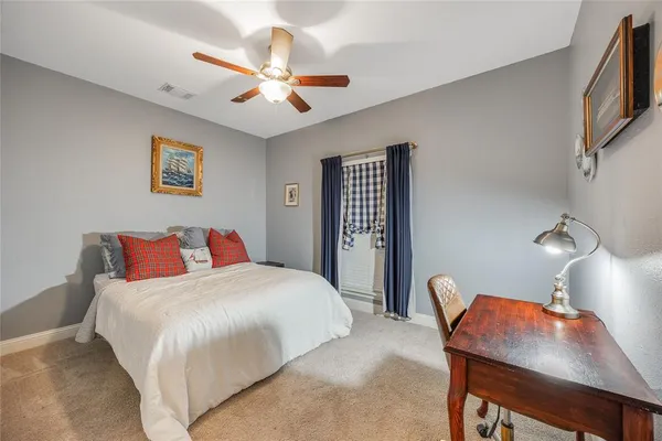 a bedroom with a bed window and a chair