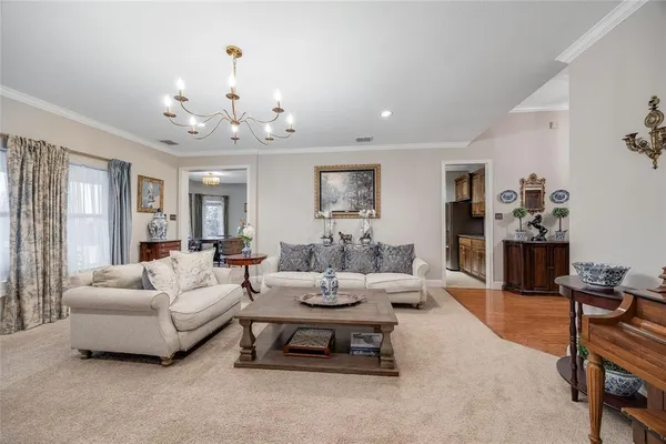 a living room with furniture and a chandelier