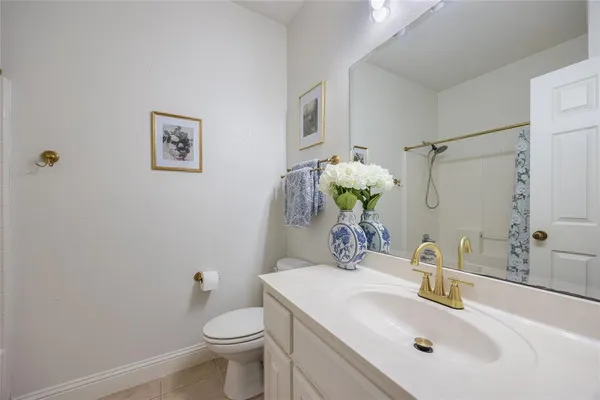 a bathroom with a sink toilet and mirror