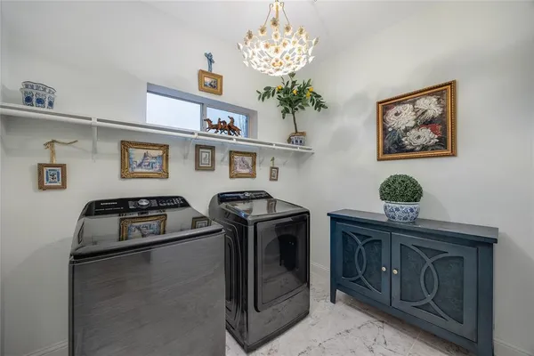 a kitchen with stainless steel appliances granite countertop a stove a washer and dryer