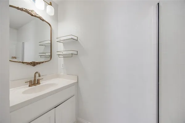a bathroom with a sink and mirror