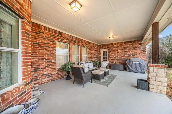 a balcony with furniture and a potted plant