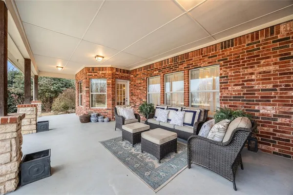 a living room with furniture and a floor to ceiling window
