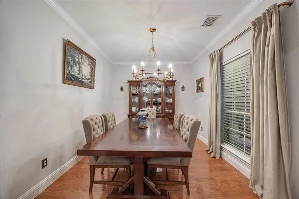 a view of a dining room with furniture and chandelier