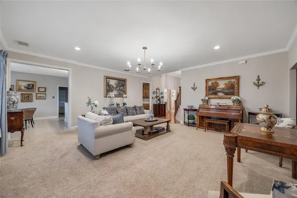 a living room with furniture and a chandelier