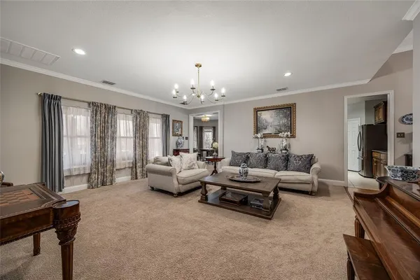 a living room with furniture and large windows