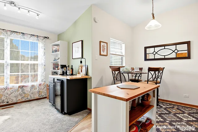 a view of a kitchen area with furniture and windows