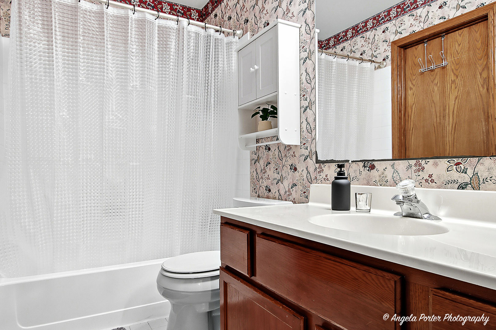 911 Ann Arbor Lane, Unit 253 Vernon Hills, IL 60061 - Photo 15 of 26 a bathroom with a sink a toilet and shower curtain