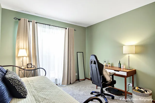 a bedroom with a bed a desk and a dresser