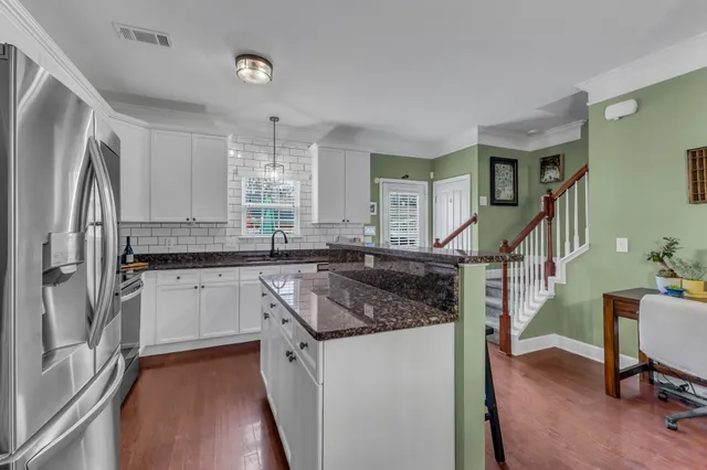 a kitchen with sink refrigerator and window