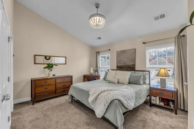 a bedroom with a bed and a chandelier
