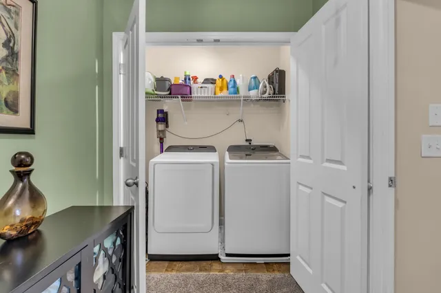 a bedroom with a bed a dresser and a flat screen tv