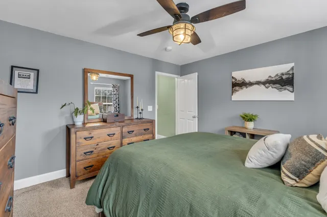a bathroom with a double vanity sink toilet and a mirror