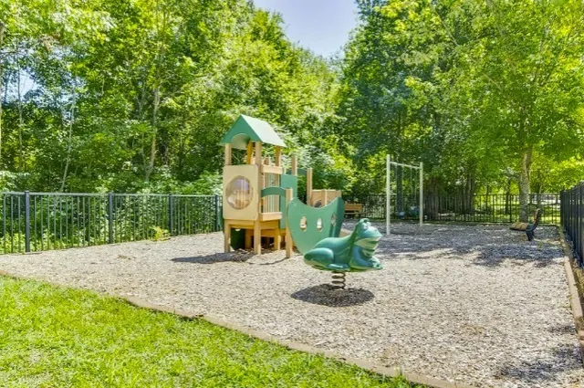 a view of a swimming pool with a yard and green space