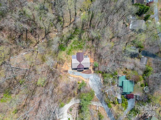 a view of a backyard with wooden fence