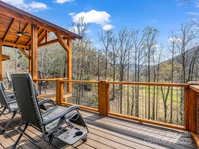 a view of balcony with wooden floor and outdoor seating