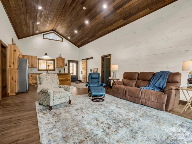 a bedroom with a bed and a dresser next to a window