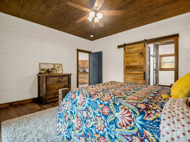 a spacious bathroom with a granite countertop sink and a mirror