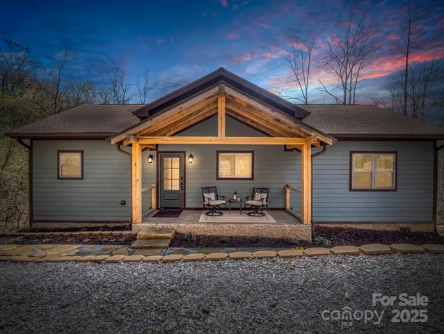 a front view of a house with outdoor seating