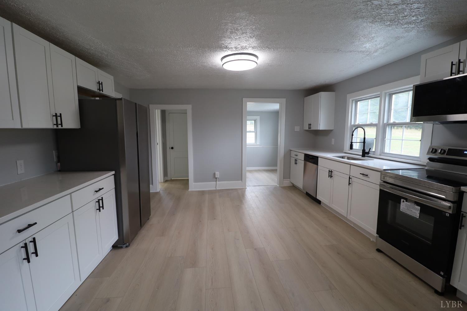 2079 Pin Oak Road Prospect, VA 23960 - Photo 3 of 8 a kitchen with stainless steel appliances a sink dishwasher a refrigerator and a stove top oven