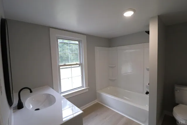 a bathroom with a tub sink and vanity