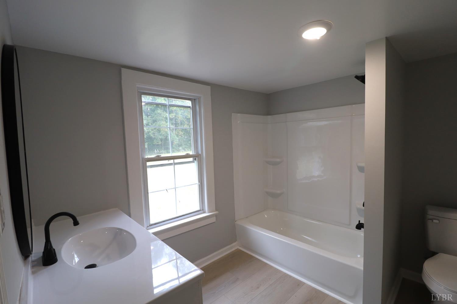 2079 Pin Oak Road Prospect, VA 23960 - Photo 4 of 8 a bathroom with a tub sink and vanity