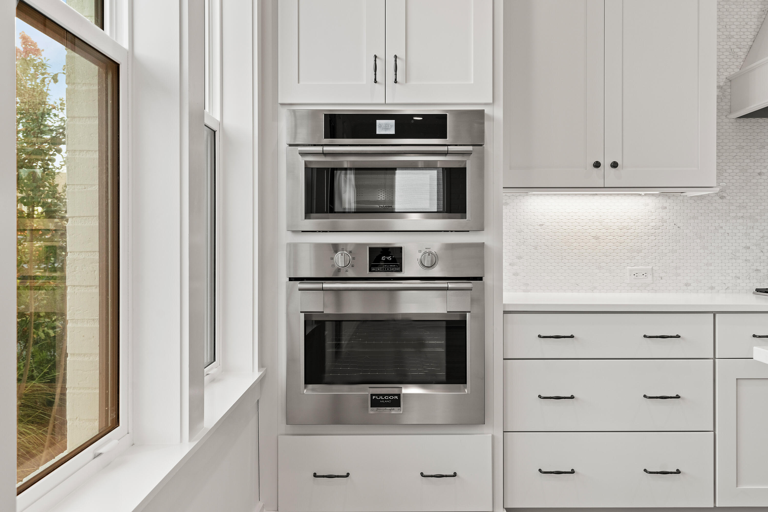 406 Ridgewalk Circle Santa Rosa Beach, FL 32459 - Photo 11 of 69 a kitchen with white cabinets and stainless steel appliances