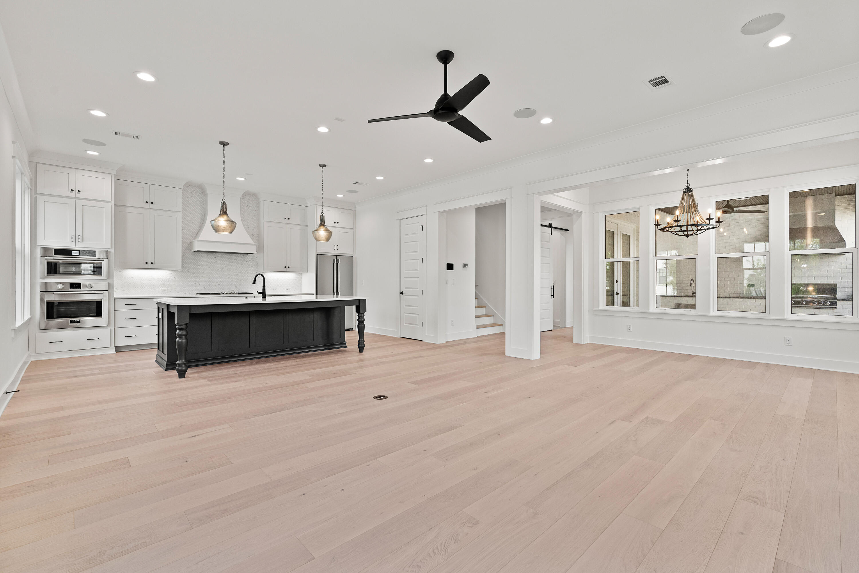 406 Ridgewalk Circle Santa Rosa Beach, FL 32459 - Photo 12 of 69 a large white kitchen with large windows and a fireplace