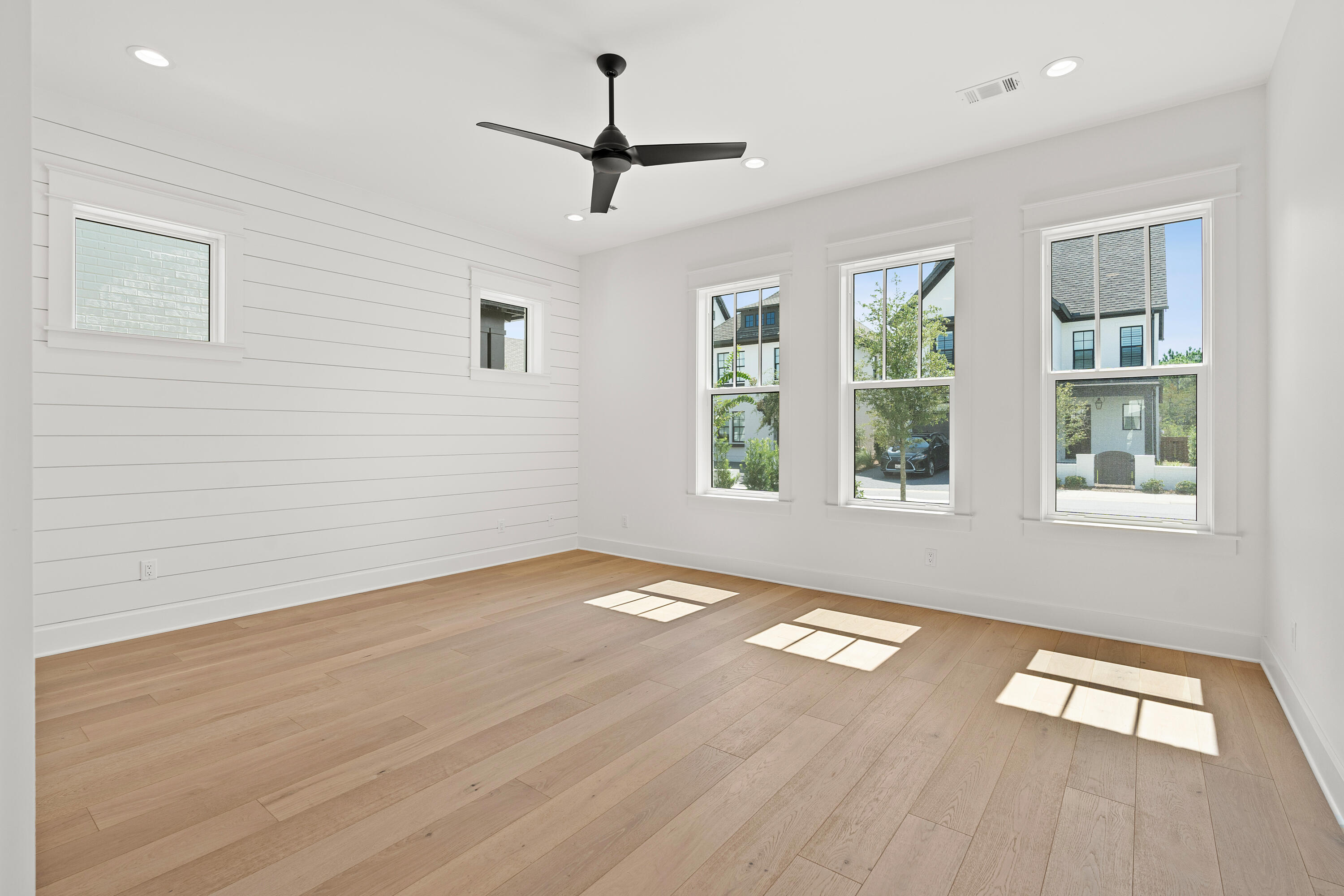 406 Ridgewalk Circle Santa Rosa Beach, FL 32459 - Photo 18 of 69 a view of an empty room with a window and wooden floor