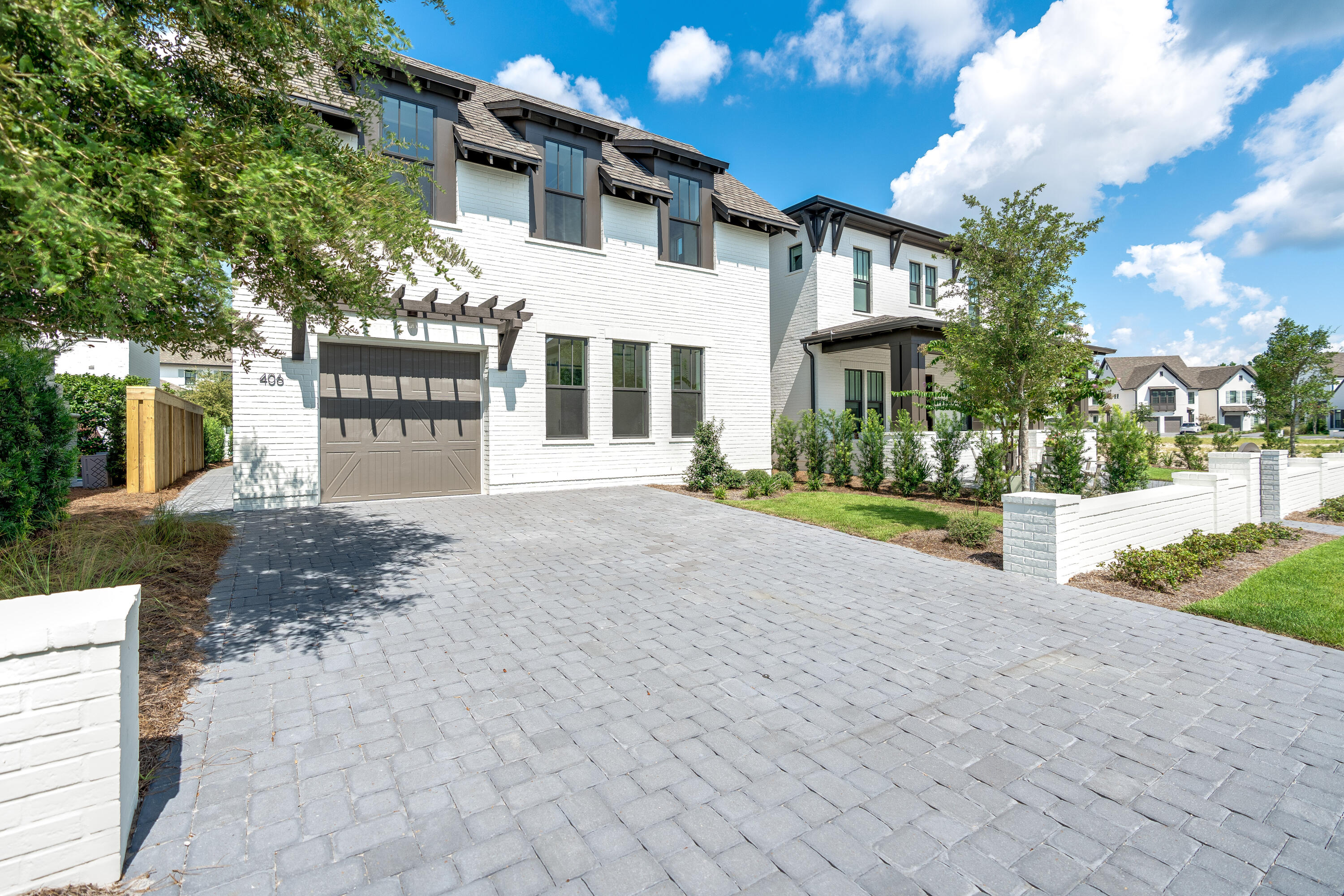 406 Ridgewalk Circle Santa Rosa Beach, FL 32459 - Photo 2 of 69 a front view of a house with a yard and garage