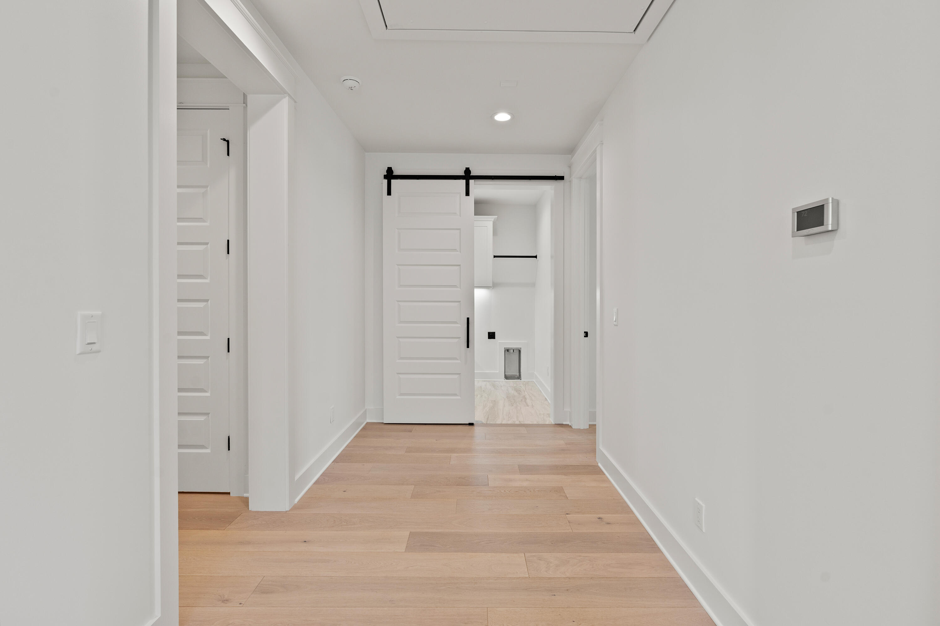 406 Ridgewalk Circle Santa Rosa Beach, FL 32459 - Photo 29 of 69 a view of a hallway with wooden floor and a hallway