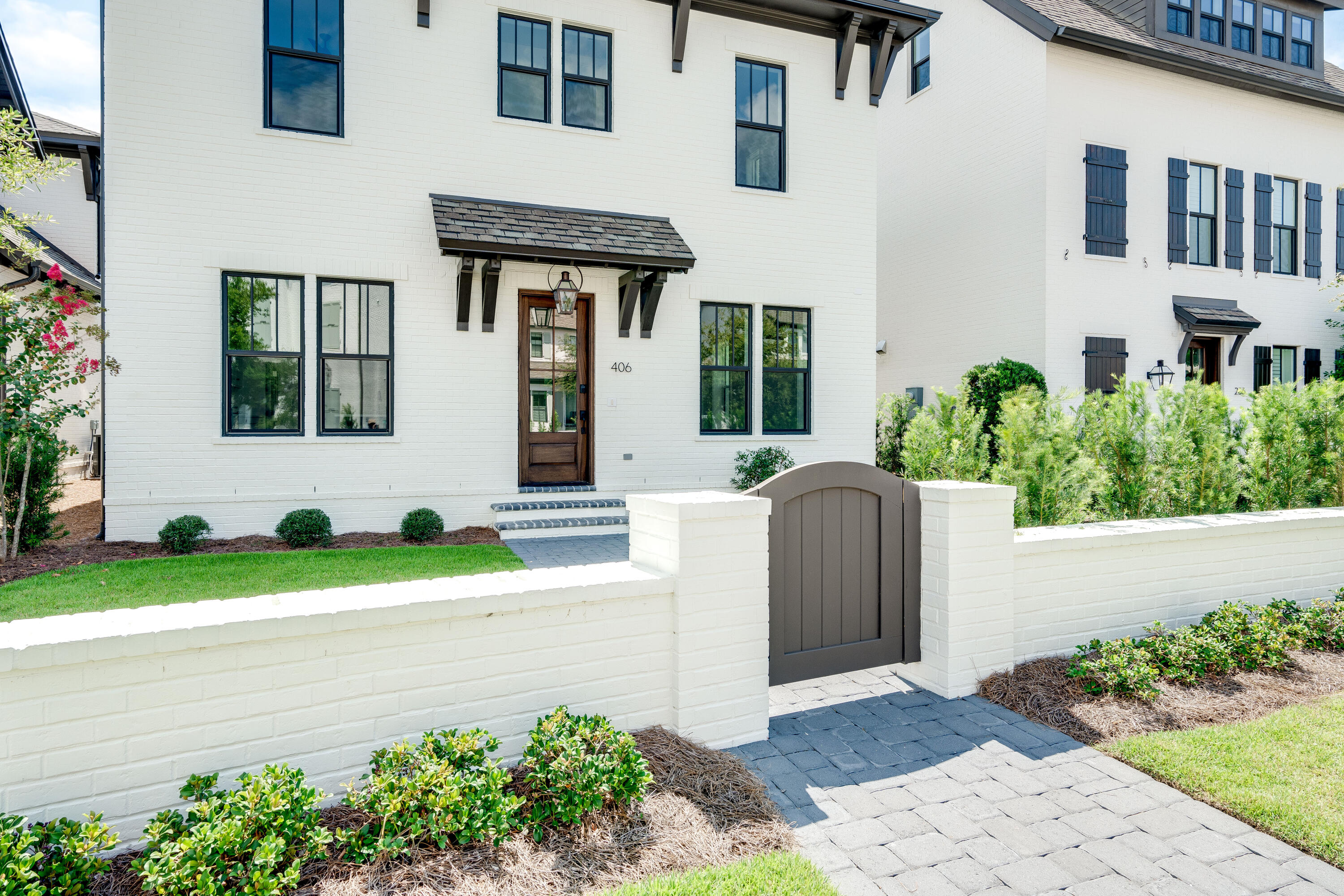 406 Ridgewalk Circle Santa Rosa Beach, FL 32459 - Photo 4 of 69 a front view of a house with a yard and potted plants