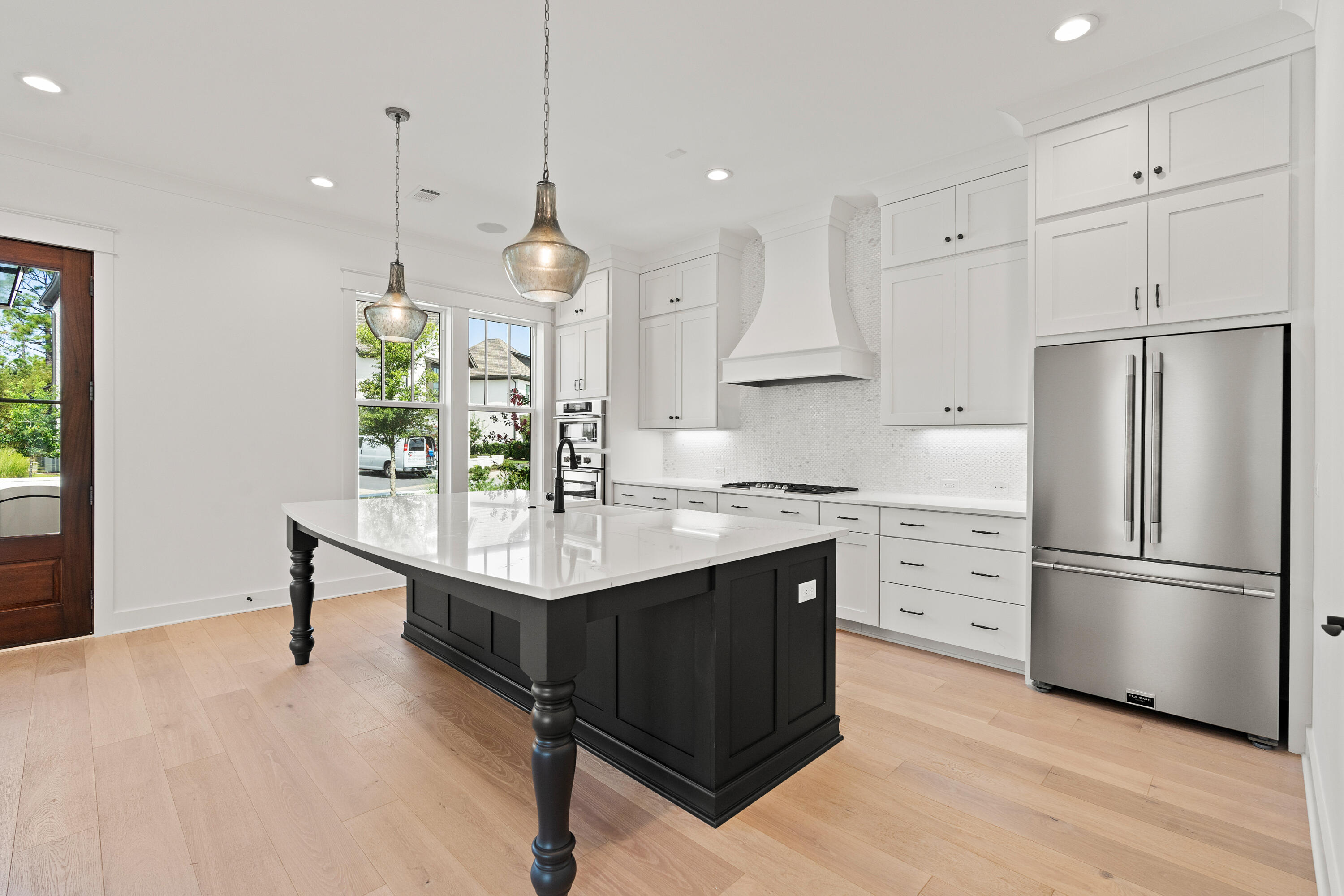 406 Ridgewalk Circle Santa Rosa Beach, FL 32459 - Photo 6 of 69 a kitchen with stainless steel appliances granite countertop a refrigerator a stove a sink dishwasher and a refrigerator with wooden floor