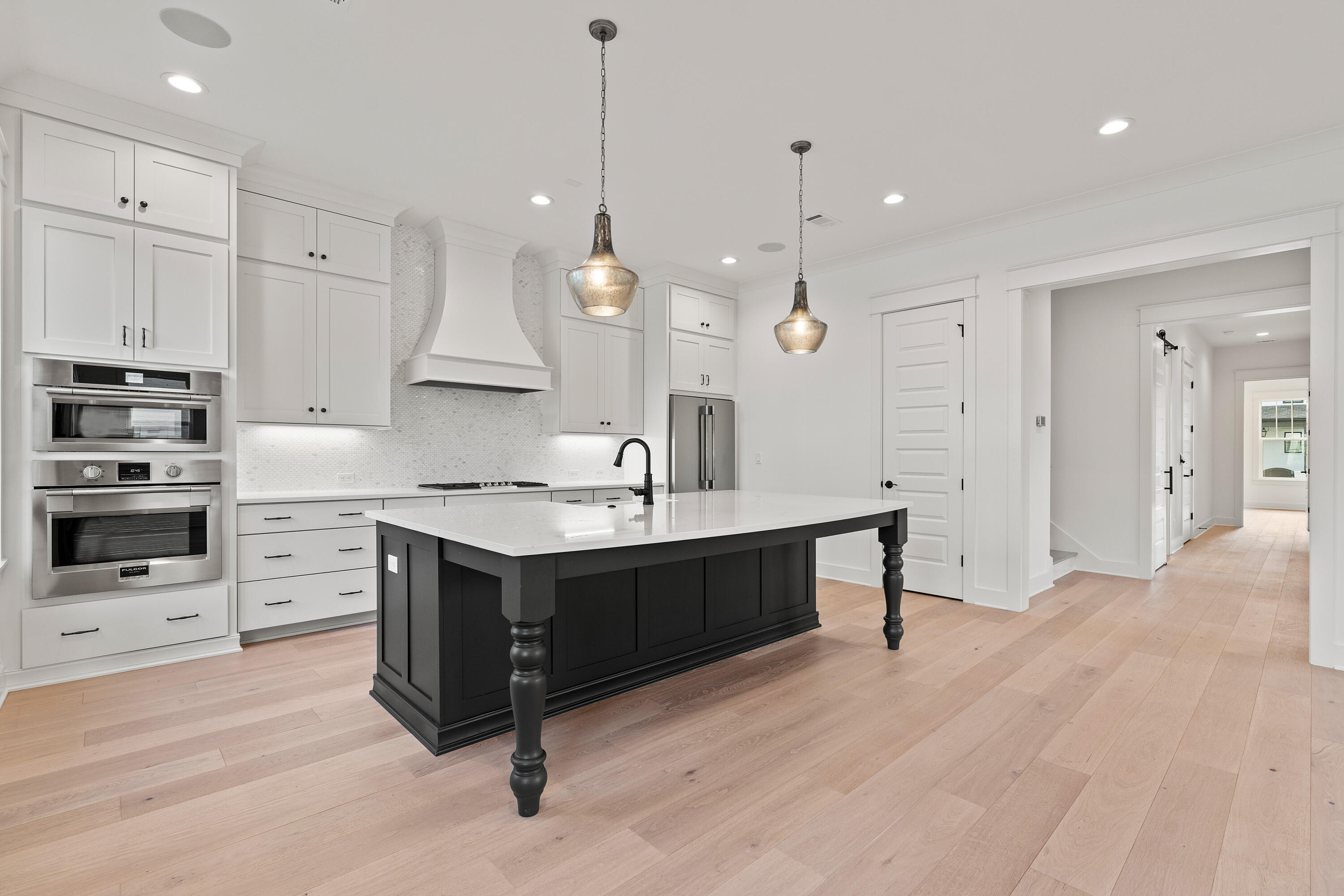 406 Ridgewalk Circle Santa Rosa Beach, FL 32459 - Photo 8 of 69 a large kitchen with cabinets wooden floor and stainless steel appliances