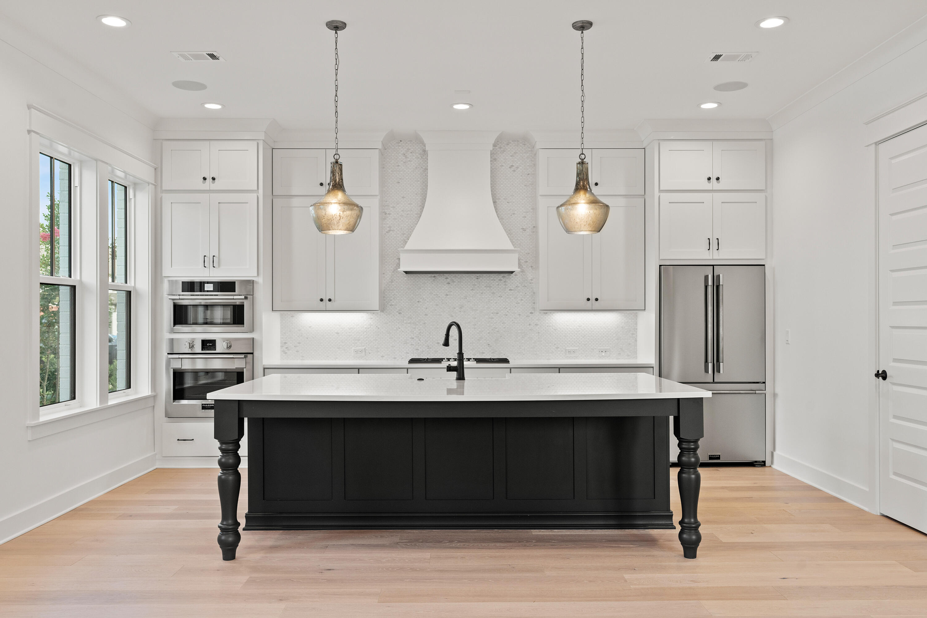 406 Ridgewalk Circle Santa Rosa Beach, FL 32459 - Photo 9 of 69 a kitchen with kitchen island granite countertop a sink a center island and a window