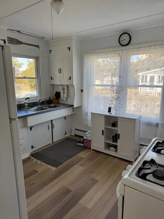 a kitchen with a stove a window and a refrigerator