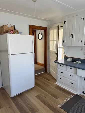 a white refrigerator freezer sitting in a kitchen