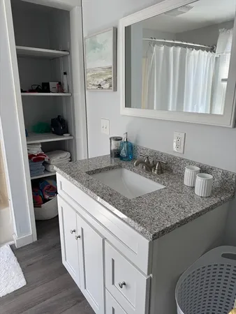 a kitchen with granite countertop a sink dishwasher stove and cabinets