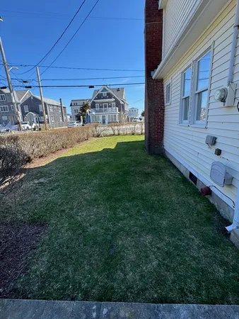 a view of front door and small yard