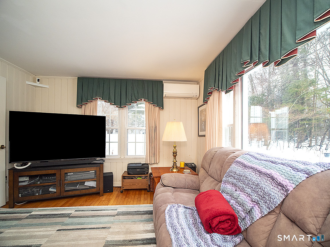 71 Vista Road North Haven, CT 06473 - Photo 13 of 32 a living room with furniture and a flat screen tv