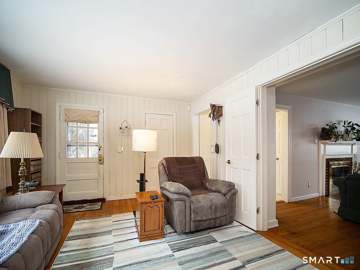 71 Vista Road North Haven, CT 06473 - Photo 14 of 32 a living room with furniture a fireplace and a table