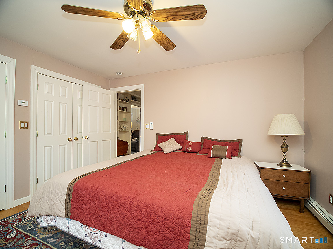 71 Vista Road North Haven, CT 06473 - Photo 17 of 32 a bedroom with a bed and a chandelier