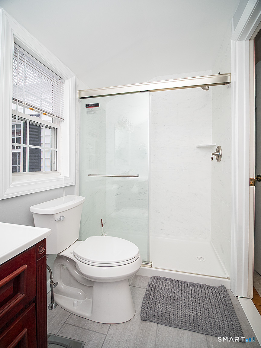 71 Vista Road North Haven, CT 06473 - Photo 27 of 32 a white toilet sitting next to a bathroom sink