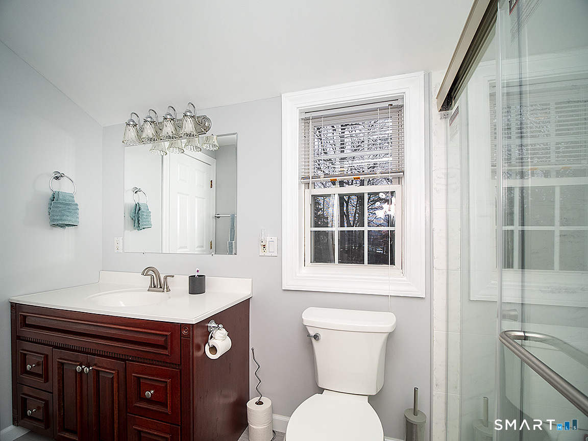 71 Vista Road North Haven, CT 06473 - Photo 28 of 32 a bathroom with a sink a toilet and a mirror