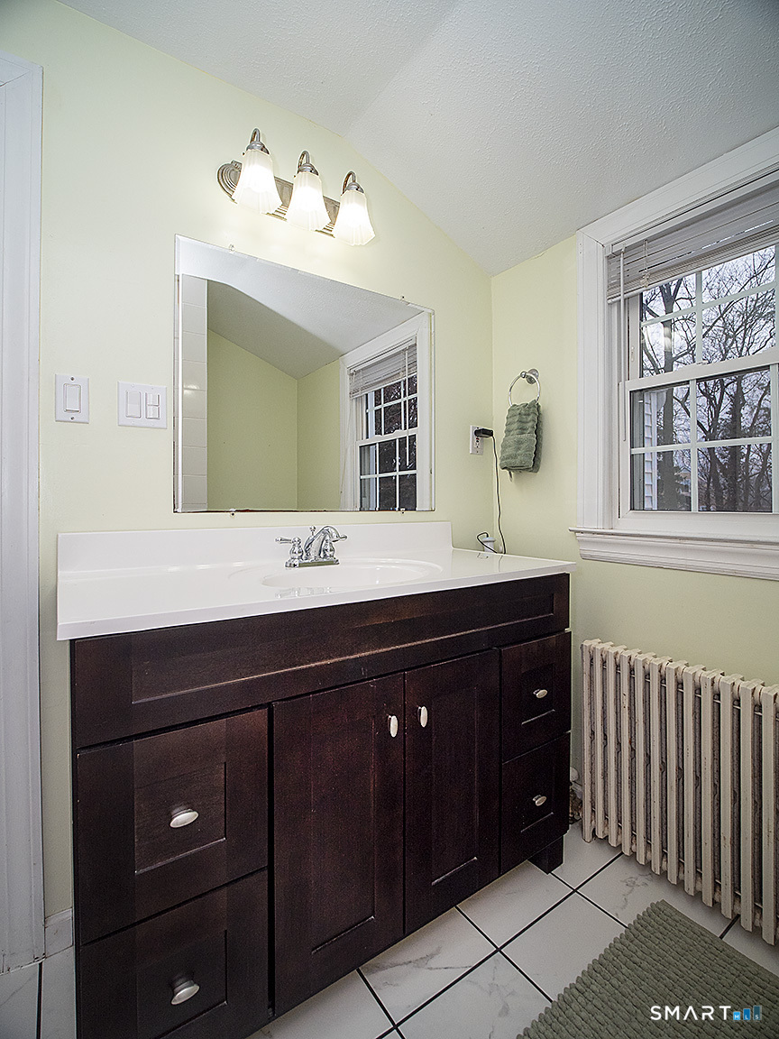 71 Vista Road North Haven, CT 06473 - Photo 30 of 32 a bathroom with a sink vanity and a mirror